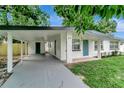 Charming single-story home featuring a carport, light blue door, and freshly painted white exterior at 517 Fairhope Dr, Apollo Beach, FL 33572