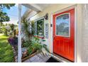 Inviting front entry with a vibrant red door and a charming 