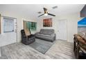 Bright living room featuring a ceiling fan, gray sofa, and hardwood floors at 6084 71St N Ave, Pinellas Park, FL 33781