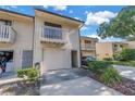 View of townhome with a balcony, garage, and tidy landscaping at 6236 93Rd N Ter # 3502, Pinellas Park, FL 33782