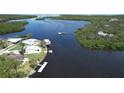 Aerial view of waterfront homes showing boat docks and lush mangrove islands in a winding waterway at 6711 Arroyo Dr, New Port Richey, FL 34652