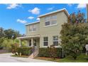 Inviting two-story home showcasing lush landscaping, complemented by a beautiful mature tree at 7333 S Trask St, Tampa, FL 33616