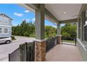 Spacious front porch with stone accents and wrought iron railings, offering a charming outdoor space at 7333 S Trask St, Tampa, FL 33616