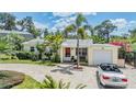 Charming single story home with a brick driveway, lush landscaping, and a one car garage at 751 Bayshore Dr, Tarpon Springs, FL 34689
