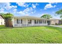 Attractive single story home with a manicured lawn, white picket fence and a one car garage at 7841 Royal Stewart Dr, New Port Richey, FL 34653