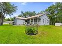 Charming single-story home with manicured lawn and cozy front porch perfect for relaxing outdoors at 8600 Shenandoah Run, Wesley Chapel, FL 33544