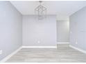 Bright living area with stylish chandelier and light wood-look flooring at 9481 Highland Oak Dr # 1506, Tampa, FL 33647