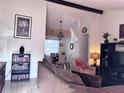 Bright and spacious living room boasts neutral paint, vaulted ceilings, and comfortable furniture at 10102 Missy Ct, Tampa, FL 33615