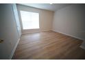 Bright bedroom with hardwood floors, a large window, and neutral walls, creating a serene atmosphere at 10409 Villa View Cir # 10409, Tampa, FL 33647