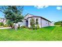 Lovely single-story home with a brick driveway, bay window, well-kept lawn, and tidy landscaping at 10842 Rolling Moss Rd, Tampa, FL 33647