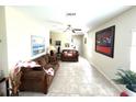 Cozy living room with tile floors, comfortable seating, and vibrant artwork, ideal for relaxing or entertaining at 11309 Villas On The Green Dr, Riverview, FL 33579