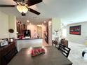 Bright open-concept space features a dining table, kitchen with granite countertops, and a spacious living area at 11309 Villas On The Green Dr, Riverview, FL 33579