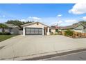 Charming single-story home with a two-car garage and spacious concrete driveway at 11422 Brown Bear Ln, Port Richey, FL 34668