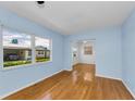 Bright living room with hardwood floors, light blue walls, and a large window at 12400 Park Blvd # 311, Seminole, FL 33772