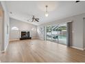 Bright and open living room with a fireplace and access to the outdoor pool area at 13986 Bonnie Brae Dr, Largo, FL 33774