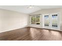 Bright living room featuring wood floors, a large window, and a glass door to a patio at 1421 Vinetree Dr, Brandon, FL 33510