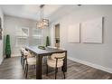 Dining room with a dark wood table and modern light fixture above, bright airy feel at 14626 Horse Trot Rd, Lithia, FL 33547