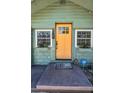 Inviting front entrance with a bright yellow door, flower boxes, and clear home security signage at 1801 52Nd S St, Gulfport, FL 33707