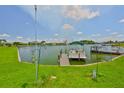 Waterfront backyard featuring a private dock, perfect for boating at 1811 Milford Cir, Sun City Center, FL 33573