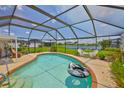 Screened-in pool with outdoor seating and serene water views at 1811 Milford Cir, Sun City Center, FL 33573