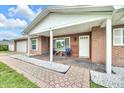 Beautiful brick home with a covered porch, stone landscaping, and a well-maintained yard at 2106 Sherbrook Dr, Valrico, FL 33594