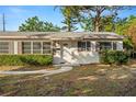 Well-maintained home featuring a pristine white front door, complemented by neat landscaping at 2145 68 S Ave, St Petersburg, FL 33712