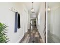Inviting foyer with wood-look flooring, modern light fixtures, and a convenient coat rack at 2405 W North B St # 1, Tampa, FL 33609
