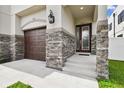 Inviting front porch featuring stone accents, stylish lighting and a modern front door at 2405 W North B St # 1, Tampa, FL 33609