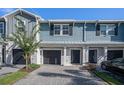 Charming townhome featuring a well-maintained front yard, paved driveway, and attached garage at 2919 Grand Kemerton Pl, Tampa, FL 33618