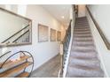 Inviting hallway with tile flooring and stairs leading to the upper level at 2919 Grand Kemerton Pl, Tampa, FL 33618