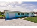 Charming single-story home featuring a well-manicured lawn and an attached one car garage at 3316 Port Charlotte Blvd, Port Charlotte, FL 33952