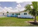 Charming single-story home featuring a well-manicured lawn and an attached one car garage at 3316 Port Charlotte Blvd, Port Charlotte, FL 33952