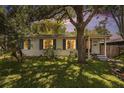 Charming single-story home with a lush front lawn and mature trees in the evening light at 3709 W San Pedro St, Tampa, FL 33629