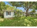 Charming single-story home with a lush front lawn and mature palm trees at 3709 W San Pedro St, Tampa, FL 33629