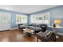 Living room with hardwood floors, natural light, and cozy seating at 5107 W Platt St, Tampa, FL 33609