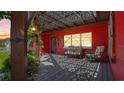 Inviting covered front porch with decorative lattice roof, outdoor seating, and views of the front yard at 5501 Highland S St, St Petersburg, FL 33705