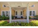 Inviting front porch with white pillars, decorative railing, and clear view of the house number at 635 Bay Ne St, St Petersburg, FL 33701