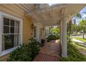 Charming front porch with tiled floor, potted plants, and decorative white pillars and railings at 635 Bay Ne St, St Petersburg, FL 33701