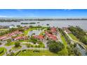 Breathtaking aerial view showcasing community homes with a serene pond and stunning ocean views at 780 Sarabay Rd # 16, Osprey, FL 34229