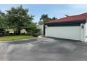 Picture showcases a charming home exterior featuring a white garage door and lush landscaping at 780 Sarabay Rd # 16, Osprey, FL 34229