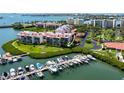 Aerial view of waterfront condos featuring boat slips, landscaping and lovely water views at 7907 Sailboat Key S Blvd # 108, South Pasadena, FL 33707