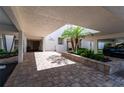 Entrance to 7907 Savannah with brick pavers, beautiful plants, and a black SUV at 7907 Sailboat Key S Blvd # 108, South Pasadena, FL 33707