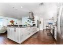 Bright, modern kitchen with a large center island, stainless steel appliances, and hardwood floors at 909 Silver Palm Way, Apollo Beach, FL 33572