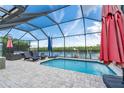 Relaxing screened-in pool area with lounge chairs and waterfront views, perfect for outdoor entertaining at 909 Silver Palm Way, Apollo Beach, FL 33572