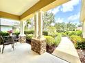 Inviting front porch featuring stone columns and ample seating area perfect for relaxing at 16413 Rivers Reach Blvd, Parrish, FL 34219