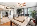 Cozy dining area featuring a modern ceiling fan and access to backyard at 2149 Dixie Garden Loop, Holiday, FL 34690
