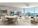 Bright, open-concept living area featuring modern decor, floor-to-ceiling windows with stunning water views, and an adjacent dining area at 235 1St S Ave # 2703, St Petersburg, FL 33701