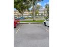 Assigned parking spot with building in the background and several cars visible at 2460 Persian Dr # 44, Clearwater, FL 33763