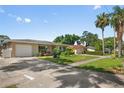 A cozy single-story house with a well-kept front lawn and space for multiple cars at 2518 Keen Park Dr, Largo, FL 33771