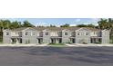 Beautiful townhome showcasing a stylish gray exterior, landscaped front yard, and convenient garage at 31262 Midnight Sun Way, Wesley Chapel, FL 33545